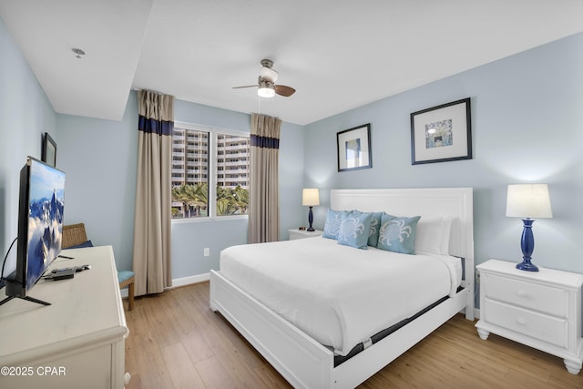 bedroom featuring ceiling fan and light hardwood / wood-style floors