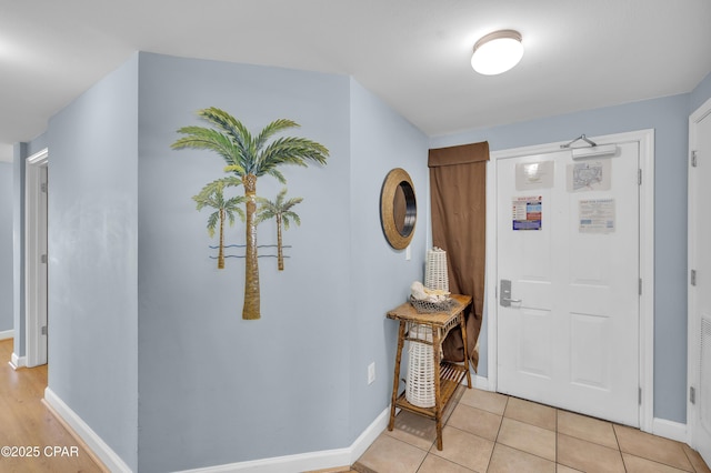 foyer entrance with light tile patterned floors