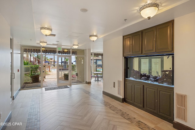 interior space featuring french doors and light parquet flooring