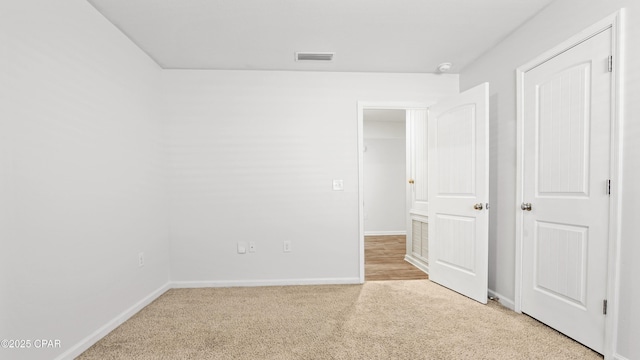 unfurnished bedroom with light colored carpet