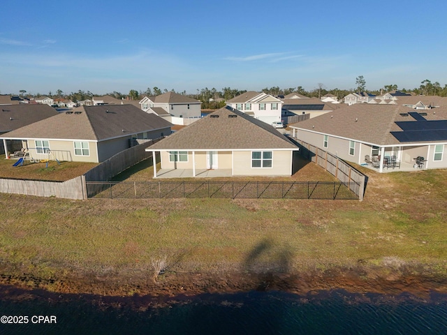 back of property featuring a water view