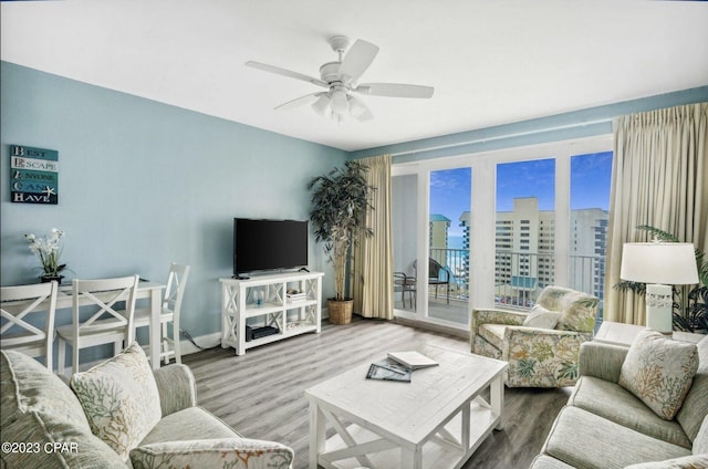 living room featuring wood-type flooring and ceiling fan