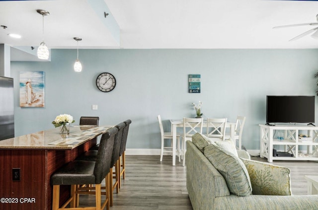 interior space with dark wood-type flooring and ceiling fan