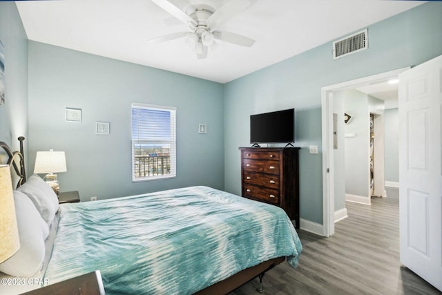 bedroom with ceiling fan and dark hardwood / wood-style flooring