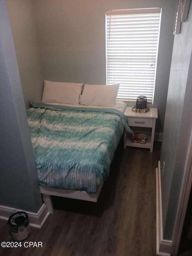 bedroom with dark wood-type flooring