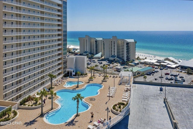 view of swimming pool featuring a water view