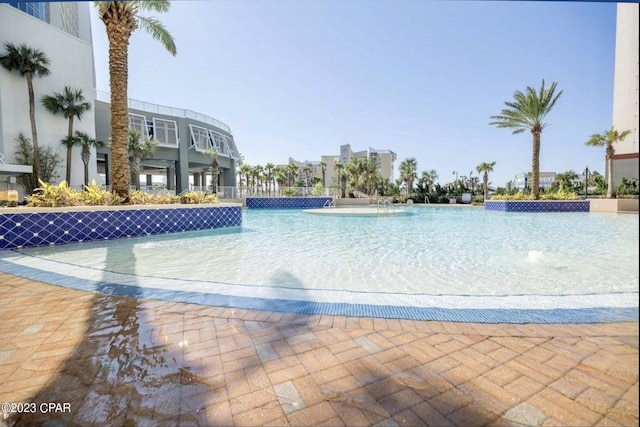 view of swimming pool with pool water feature