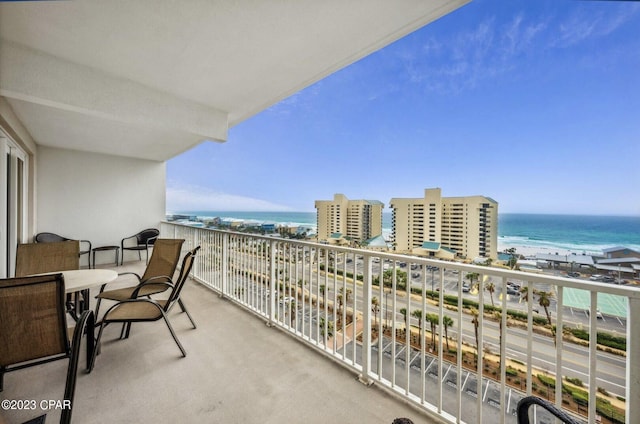 balcony featuring a water view and a view of the beach