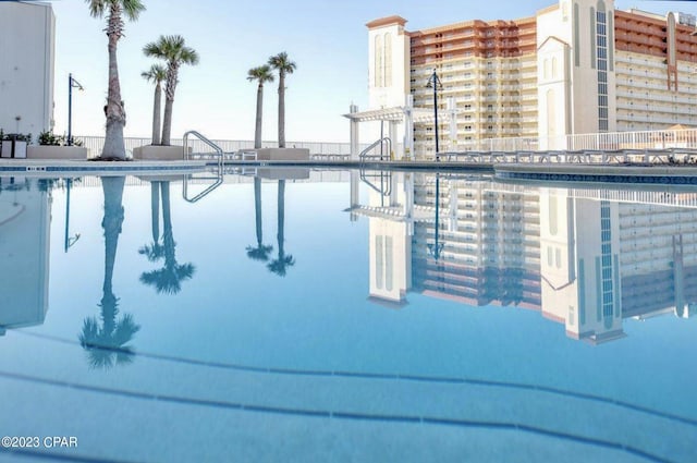 view of pool featuring a water view