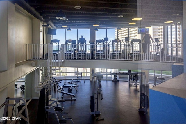 workout area with a wall of windows and a healthy amount of sunlight