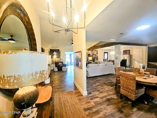 dining area with hardwood / wood-style floors, ceiling fan with notable chandelier, and vaulted ceiling