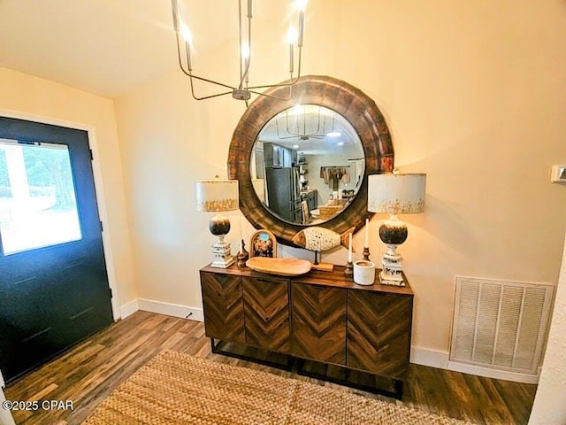 interior space with hardwood / wood-style floors and a chandelier