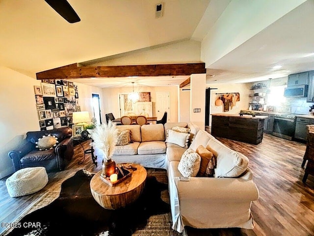 living room with lofted ceiling with beams and hardwood / wood-style flooring