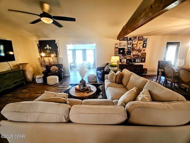 living room featuring vaulted ceiling with beams, dark hardwood / wood-style floors, plenty of natural light, and ceiling fan