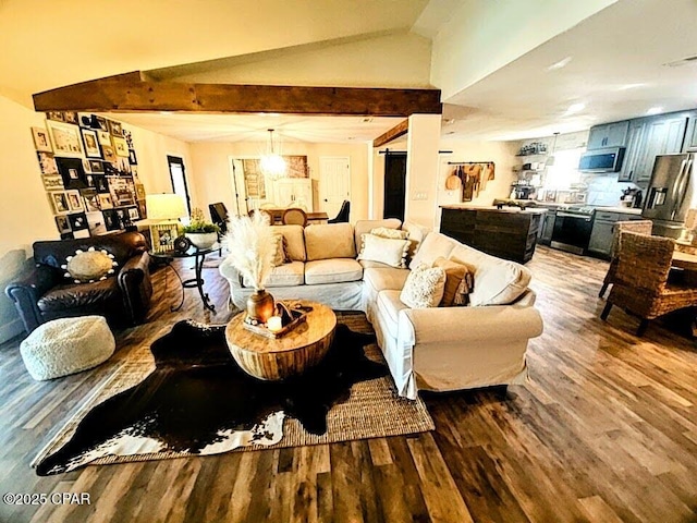 living room featuring wood-type flooring and lofted ceiling with beams