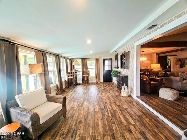 sitting room with wood-type flooring, a wealth of natural light, and a chandelier