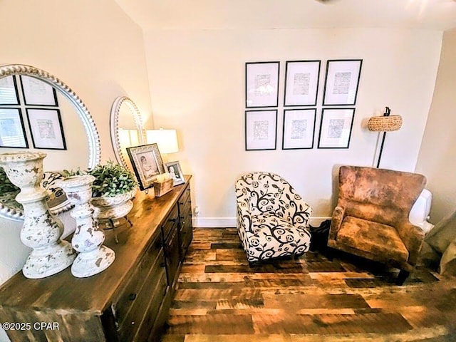 sitting room with dark wood-type flooring