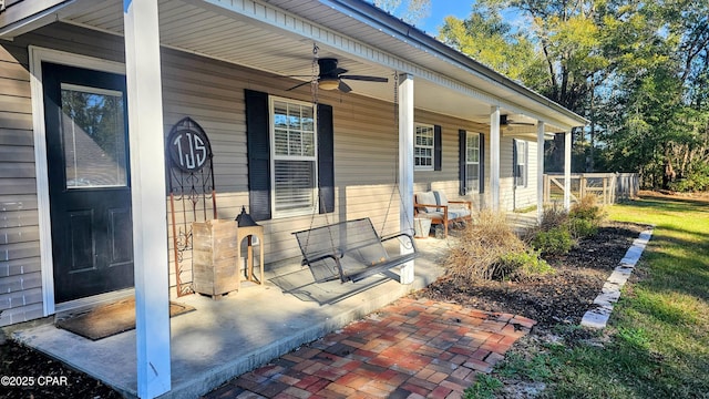 view of patio with ceiling fan and a porch