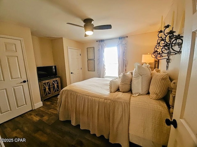 bedroom with ceiling fan and dark hardwood / wood-style flooring