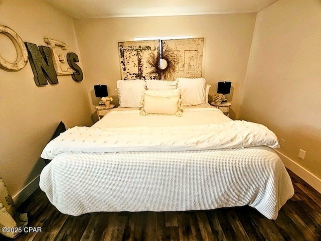 bedroom with dark wood-type flooring