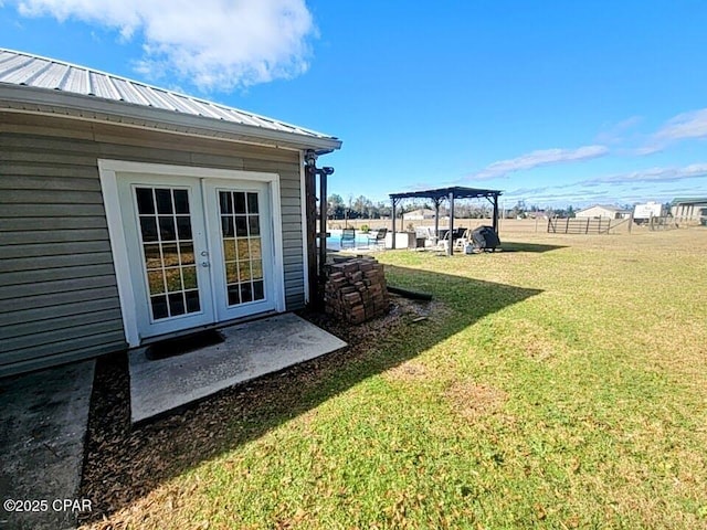 view of yard featuring a pergola and french doors