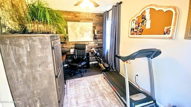 workout room featuring ceiling fan and hardwood / wood-style flooring