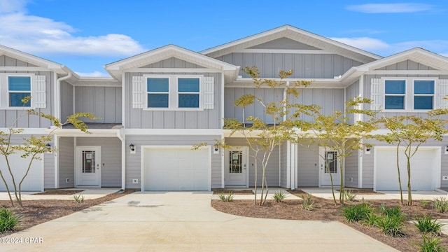 view of front of property with board and batten siding, driveway, and a garage