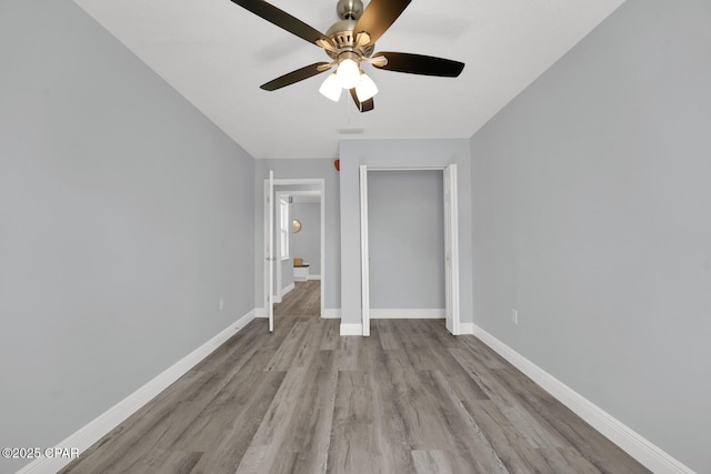 unfurnished bedroom with ceiling fan, a closet, and light hardwood / wood-style flooring