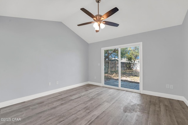 spare room featuring ceiling fan, baseboards, vaulted ceiling, and wood finished floors