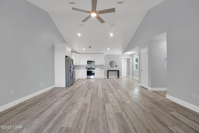 unfurnished living room featuring high vaulted ceiling, light wood-style floors, baseboards, and a ceiling fan