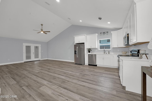 kitchen with stainless steel appliances, light wood-type flooring, light countertops, and white cabinets