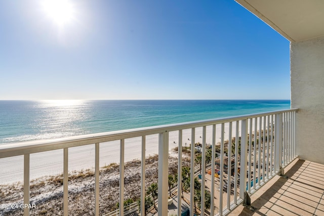 balcony featuring a water view and a view of the beach