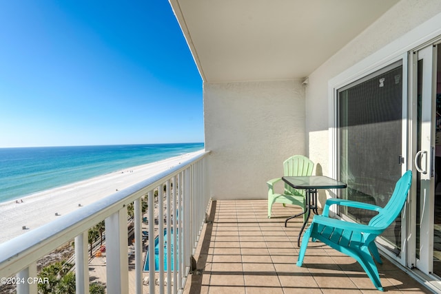 balcony with a water view and a beach view