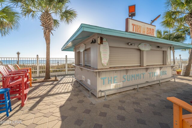 exterior space with a water view and an outdoor bar