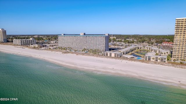 drone / aerial view with a beach view and a water view