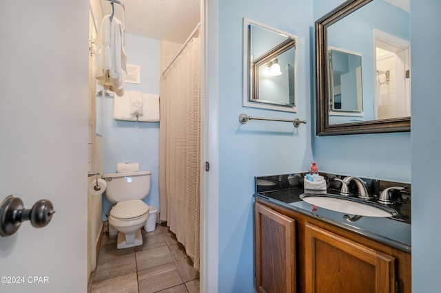 bathroom featuring toilet, tile patterned floors, and vanity