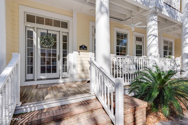 property entrance with ceiling fan and a porch