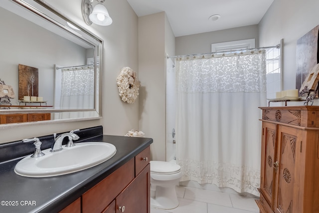 bathroom featuring toilet, tile patterned floors, walk in shower, and vanity