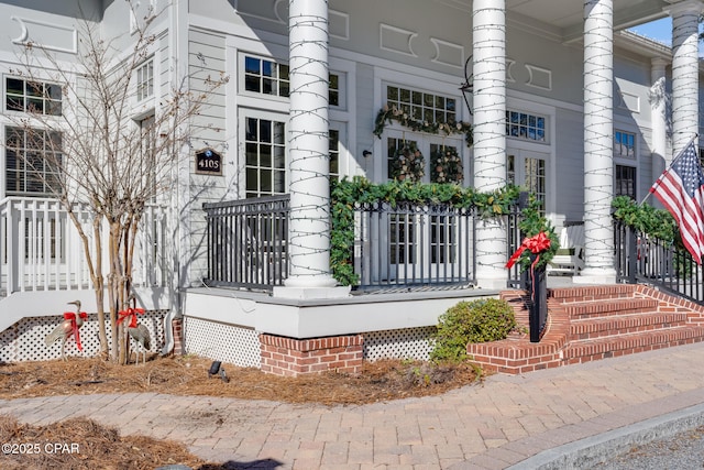 doorway to property featuring covered porch