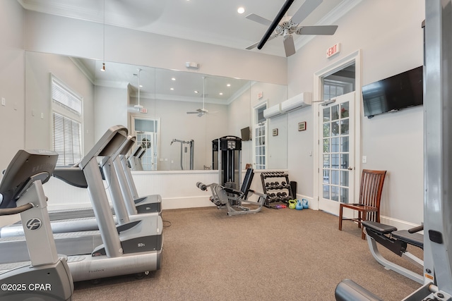 interior space with ceiling fan, a wall mounted AC, crown molding, and carpet floors