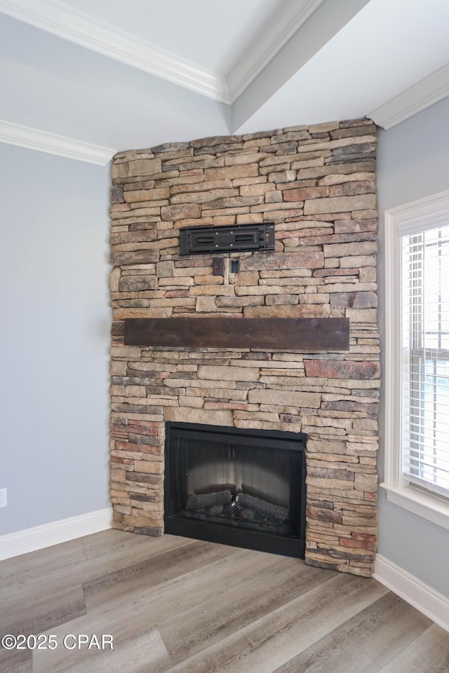 details with a stone fireplace, hardwood / wood-style floors, and ornamental molding