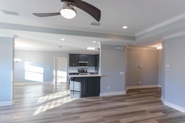 kitchen with sink, ceiling fan, ornamental molding, dark hardwood / wood-style flooring, and stainless steel appliances