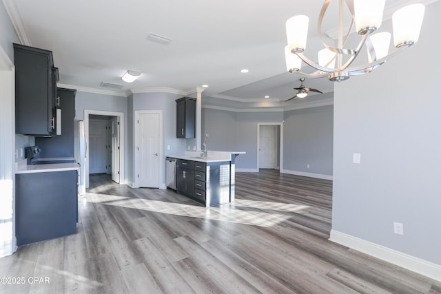 kitchen with hardwood / wood-style floors, ceiling fan with notable chandelier, sink, stainless steel dishwasher, and ornamental molding