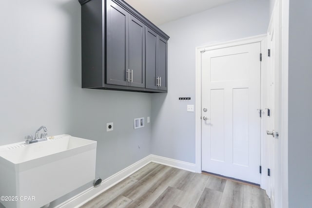 laundry area with cabinets, sink, light hardwood / wood-style flooring, washer hookup, and hookup for an electric dryer