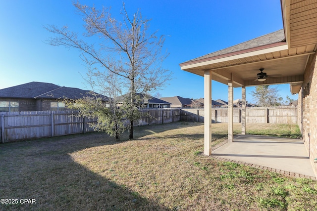 view of yard with ceiling fan and a patio