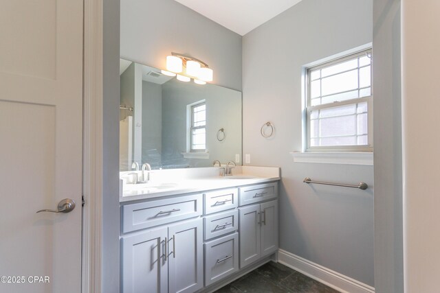 bathroom featuring vanity, tile patterned floors, and a healthy amount of sunlight