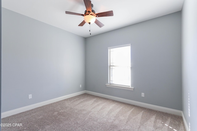 spare room with carpet and ceiling fan