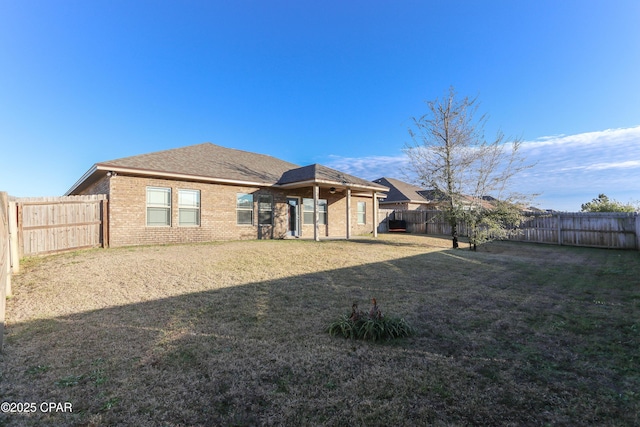 back of house with a yard