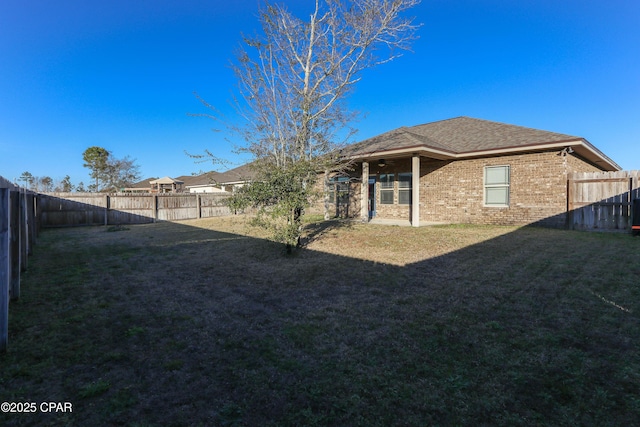 rear view of property featuring a lawn