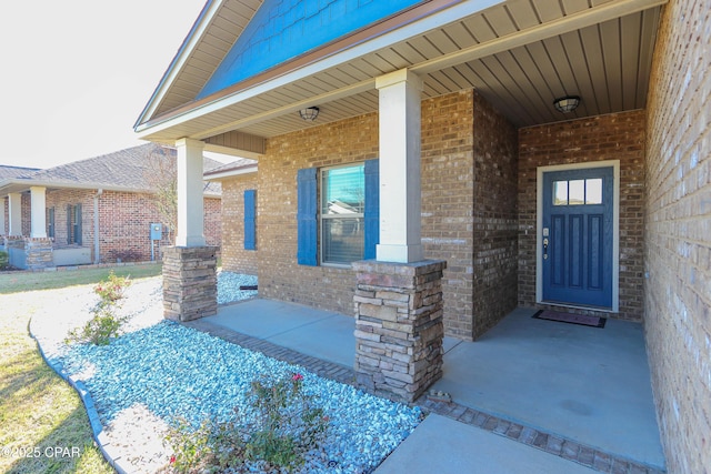 view of exterior entry with a porch